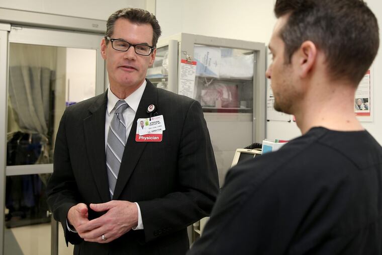 Stephen Trzeciak, a critical care doctor, and Brian Roberts, right, an emergency physician, talk at Cooper University Hospital, where both work. They are studying how compassion affects health care.