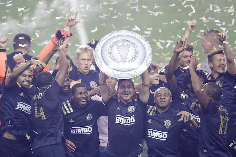 Union captain Alejandro Bedoya and his teammates celebrate winning the 2020 Supporters' Shield, the first trophy in team history.