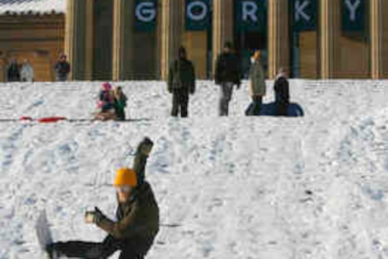 Snowboarder Jeff Stockbridge of Philadelphia loses control on the steps of the Art Museum. The No. 1 snow on record is still the storm of Jan. 7-8, 1996, which dumped 30.7 inches on the area.
