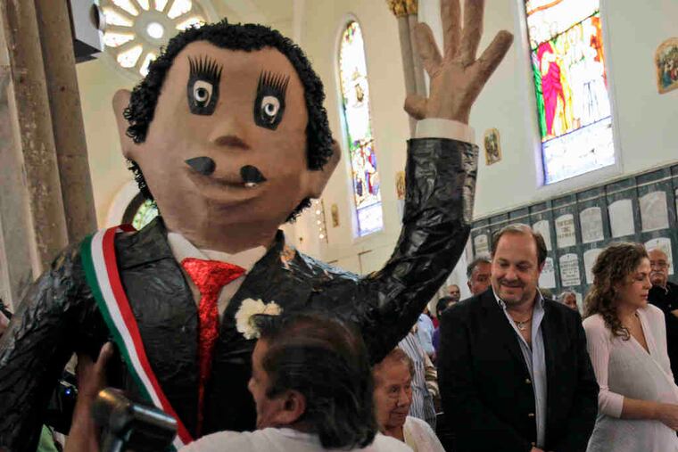 Centennial tributeMario Moreno (center), adopted son of the Mexican comedian and actor known as "Cantinflas," helps mark the 100th anniversary of his father's birth yesterday at the Mexico City cemetery where he is buried. He starred in 51 films and shorts.