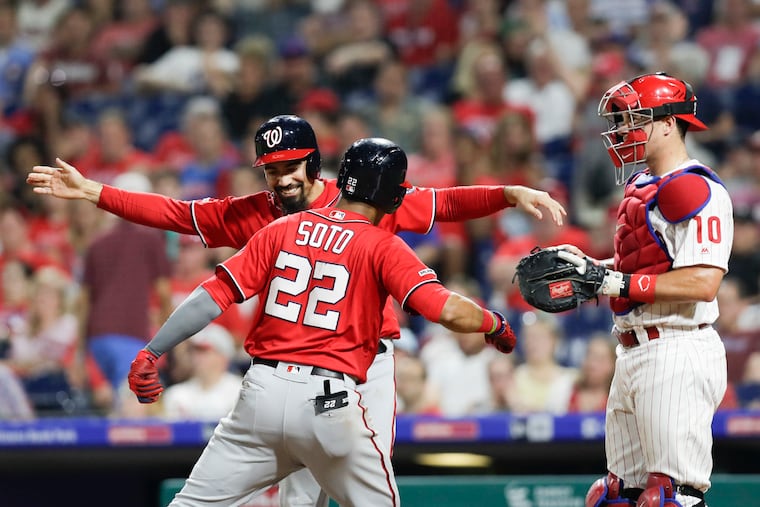 Washington Nationals Juan Soto celebrates his two run ninth-inning home run with teammate Anthony Rendon past Phillies catcher J.T. Realmuto on Saturday, July 13, 2019 in Philadelphia.