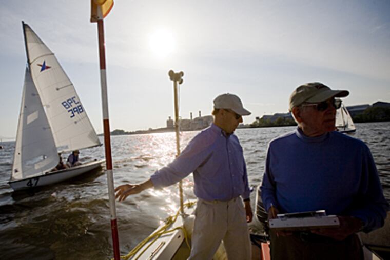 The Corinthian Yacht Club was established in 1892 in Essington, Pa. Here, Djoerd Hoekstra, left, Dr.Kaijhn Smith, right, officiate at a race. (Ed Hille / Inquirer)