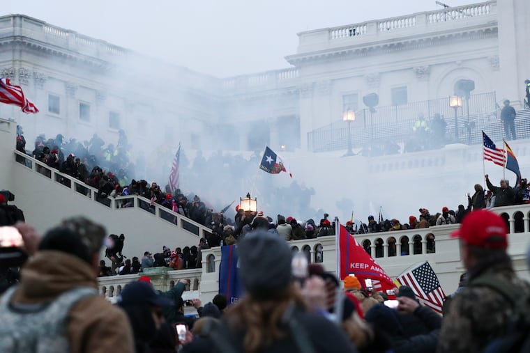 Smoke can be seen outside of the U.S. Capitol while police disperse the crowd hours after a mob of Trump supporters breached the building on Jan. 6, 2021.