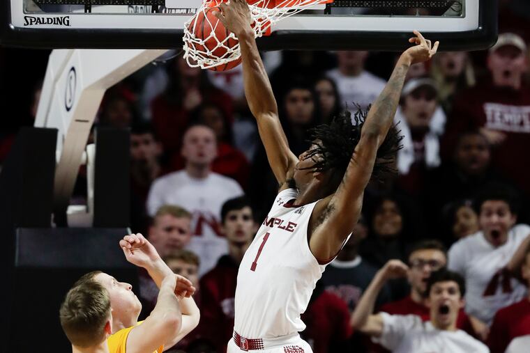 Temple guard Quinton Rose dunking past Drexel forward Tadas Kararinas during the first half last Tuesday.