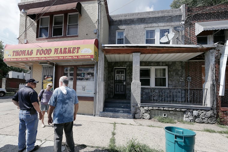 A man from the Camden Public Works Dept (left) tells residents Karen Williams and Robert Shaffer that Public Works will be back the next morning to board up 1303 Browning St. (on right) on July 26, 2018. Browning Street residents are waiting for Camden officials to clean up a mess left at an abandoned house where dogs – dead and alive – were removed earlier this month. So bad were conditions in the house, that the Post Office suspended delivery after a letter carrier was bitten by fleas. It's an usual step for the Postal Service that is citing a health concern. ELIZABETH ROBERTSON / Staff Photographer