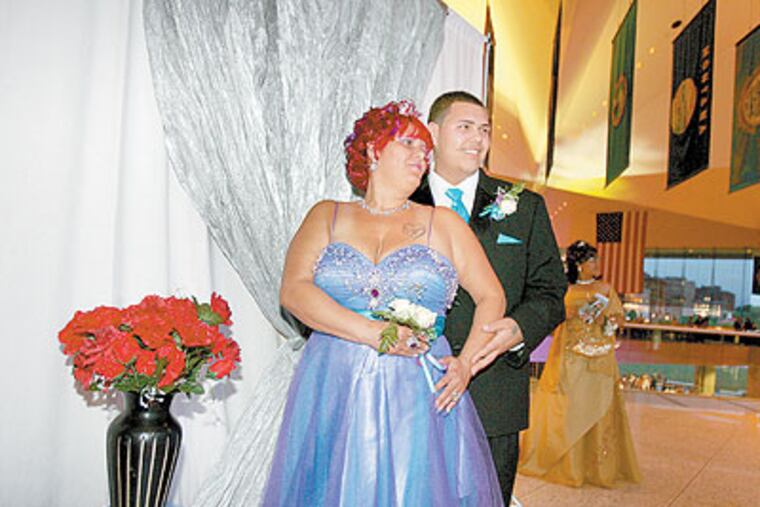 Wanda Alicea, left, and her son, Danny Guzman, have their photo taken together at the Edison High School prom at the National Constitution Center. (Charles Fox / Staff Photographer)