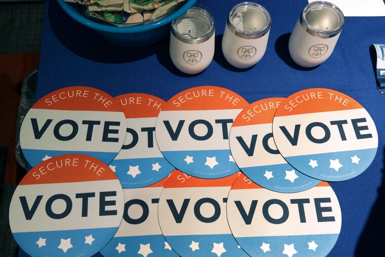 Computer mouse pads with Secure the Vote logos are on a vendor's table at a convention of state secretaries of state in Philadelphia July 14, 2018. Pennsylvania, a state that has ranked in the bottom tier in election laws, just passed a law ushering in substantive changes to its system.