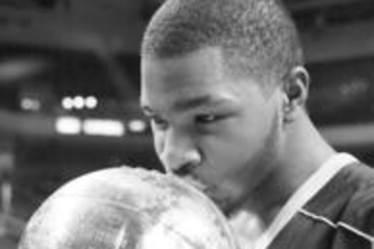 Prep Charter's Marcus Morris kisses title trophy after victory over Simon Gratz.