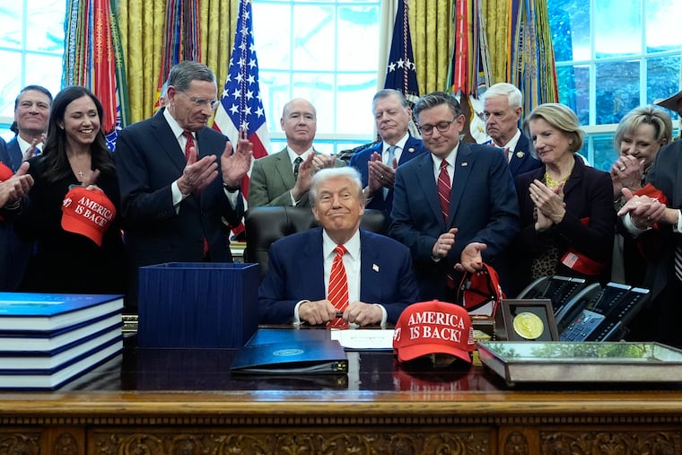 President Donald Trump smiles after signing a spending bill that ends a partial shutdown of the federal government in the Oval Office on Tuesday.