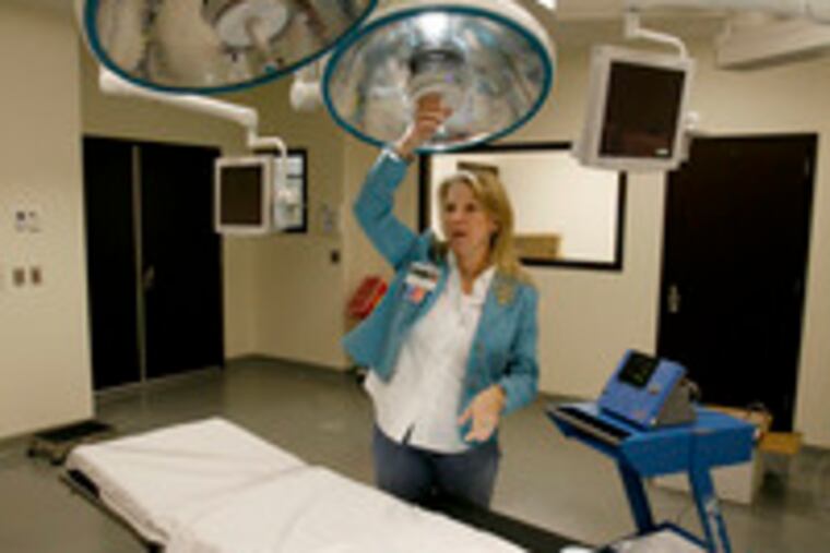 Surgeon Beth DuPree demonstrates some of the operating-room equipment at the Comprehensive Breast Care Institute at DSI of Bucks County. The new hospital in Bensalem is an affiliate of Diversified Specialty Institutes, a Nashville-based, for-profit company.