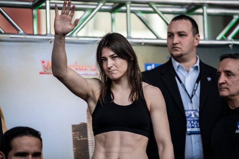 Katie Taylor, an undefeated Irish lightweight world champion, waves during a pre-fight weigh-in at the Liacouras Center in Philadelphia Pa.