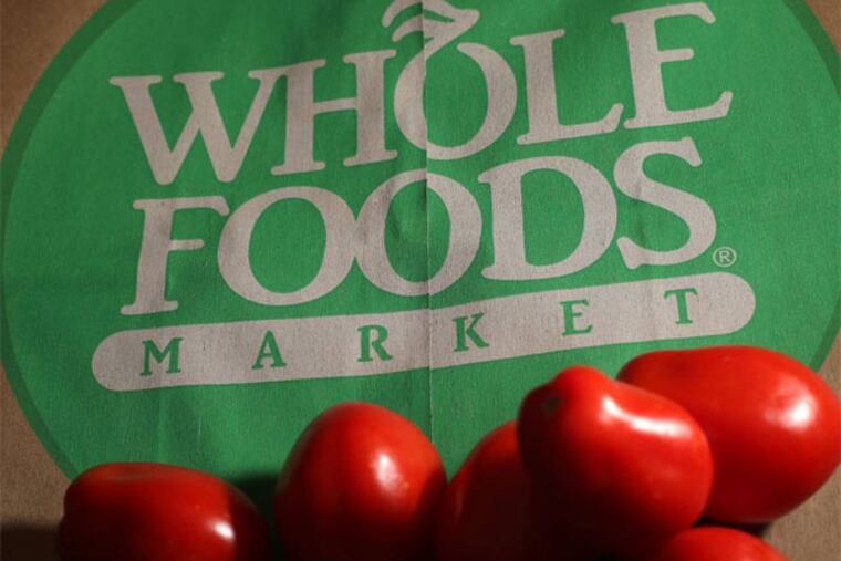 FILE - In this Monday, July 29, 2013, file photo, produce is places on Whole Foods paper bag in Andover, Mass. Whole Foods Market Inc. reports quarterly financial results after the market closes on Wednesday, Nov. 6, 2013. (AP Photo/Elise Amendola, File)