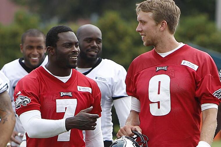 Eagles quarterbacks Michael Vick (left) and Nick Foles (right). (David Maialetti/Staff Photographer)