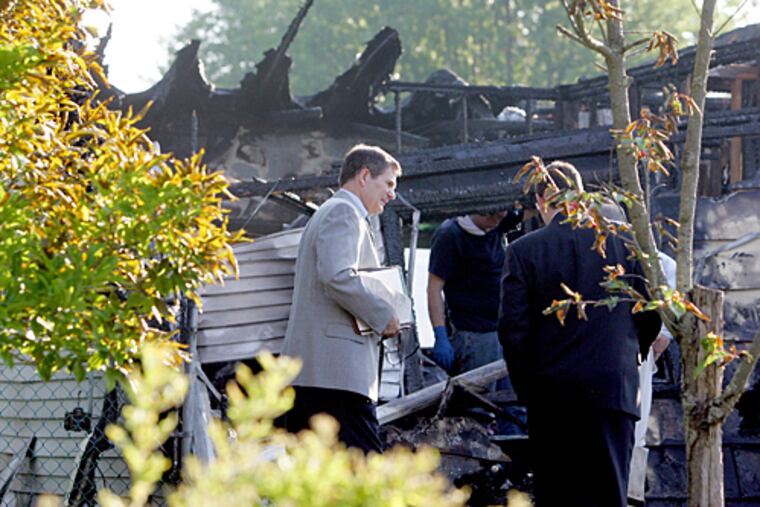 Officials are investigating the cause of explosions and a fire that killed three people in a house in Pemberton Township early Monday morning.
