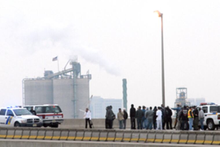 Officials wait out the three-hour standoff on the Walt Whitman Bridge. The suspect, driving a Cadillac Escalade, had been tailed by police on Route 42. Police said they broke off the chase when the motorist began driving erratically.