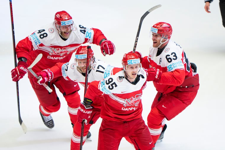 Denmark's Nick Olesen (95) celebrates with teammates after scoring the winning goal in a quarterfinal game between Canada and Denmark at the hockey world championships, Thursday, May 22, 2025, in Herning, Denmark. (Bo Amstrup/Ritzau Scanpix via AP)