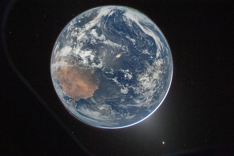 This image provided by NASA shows a view of Earth taken by NASA astronaut and Artemis II commander Reid Wiseman from the Orion spacecraft's window after completing the translunar injection burn on Thursday.