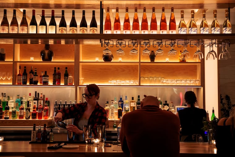 Lead bartender Mary Wood serving cocktails during a preview dinner at Banshee, 1600 South St.