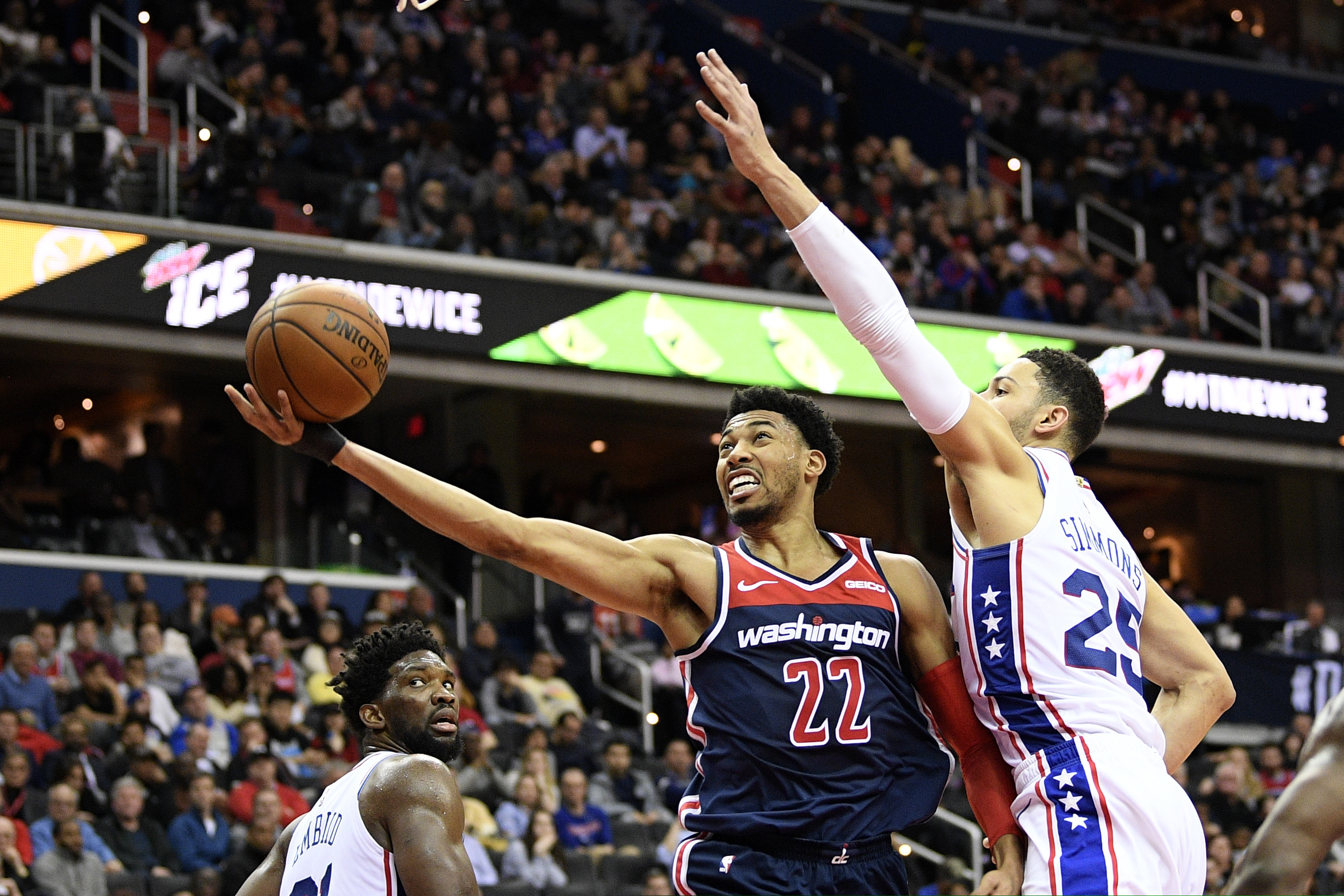 Wizards forward Otto Porter Jr. (22) goes to the basket against 76ers guard Ben Simmons during the second half.