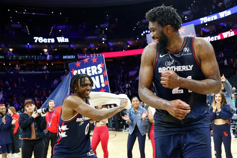 Joel Embiid celebrates with teammate Tyrese Maxey after Embiid scored 70 points against the Spurs.