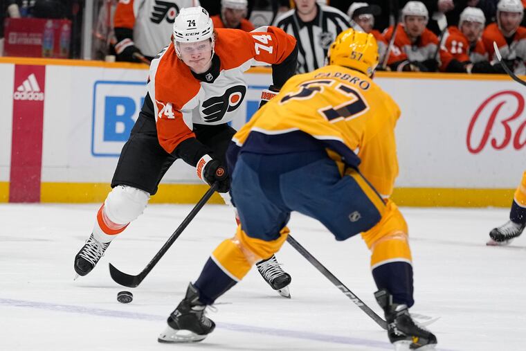Philadelphia Flyers right wing Owen Tippettmove s the puck past Nashville Predators defenseman Dante Fabbro during the first period of their game on Tuesday.