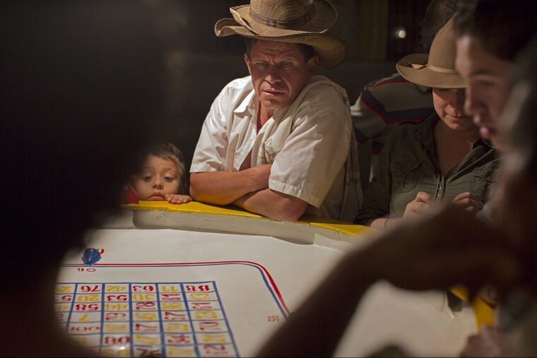 Tony Rocco’s photograph “Small Town Gambler (La Florida, Colombia)” (2012), archival pigment print, from “The Expanded Caribbean” at Drexel University’s Leonard Pearlstein Gallery.