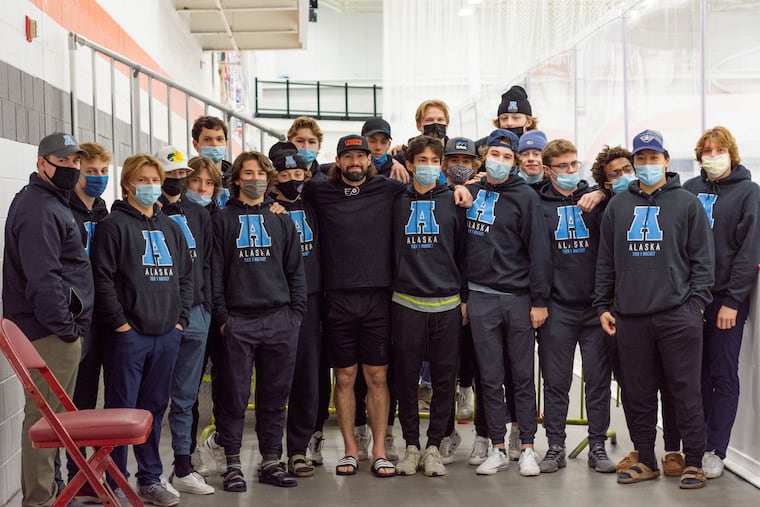 Flyers forward Nate Thompson, center, poses with Team Alaska who came to watch him practice in Voorhees, NJ, on Wednesday. The 16-year-old team was in Philadelphia for an exposure exhibition series.