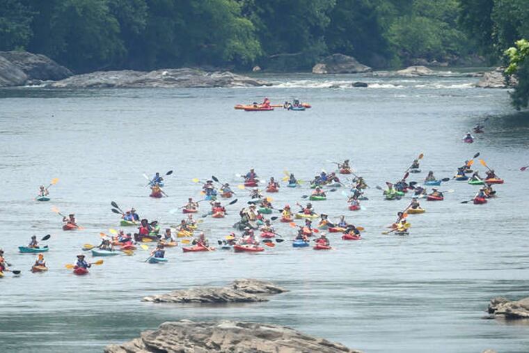 More than 100 kayakers and canoeists paddle down the Schuylkill near Manayunk after a 100-plus mile trip in the 17th annual Schuylkill River Sojourn in 2018.