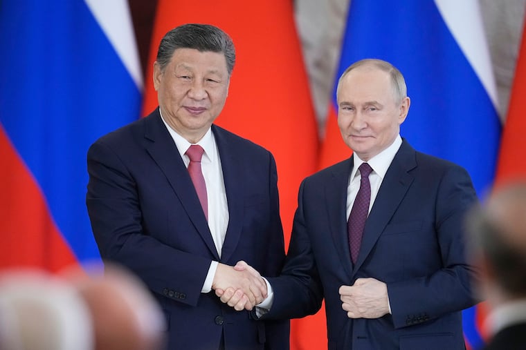 Russian President Vladimir Putin and Chinese President Xi Jinping shake hands at the Kremlin in Moscow in May.