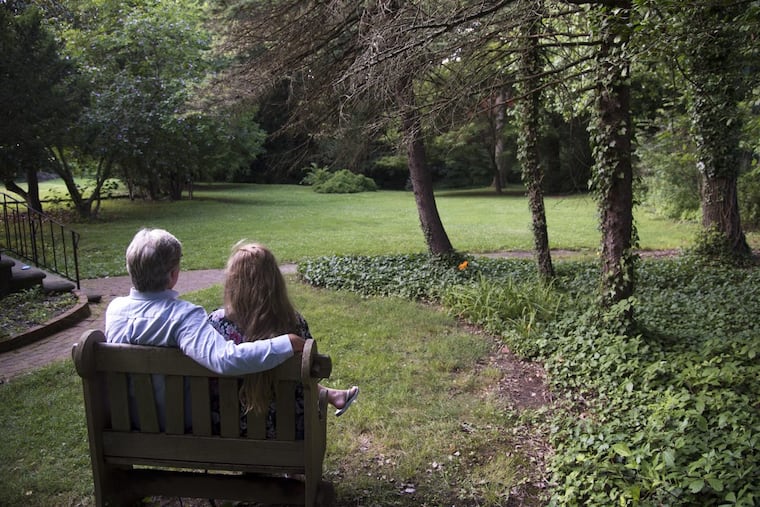 Matthew Doherty and daughter Allison look towards wooded area outside the cottage he rents just behind Boxwood Hall in the borough of Haddonfield.