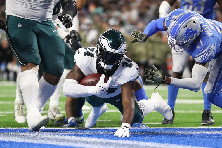 Eagles running back Jordan Howard scores a second quarter touchdown past Detroit Lions free safety Tracy Walker III on Sunday, October 31, 2021 in Detroit.