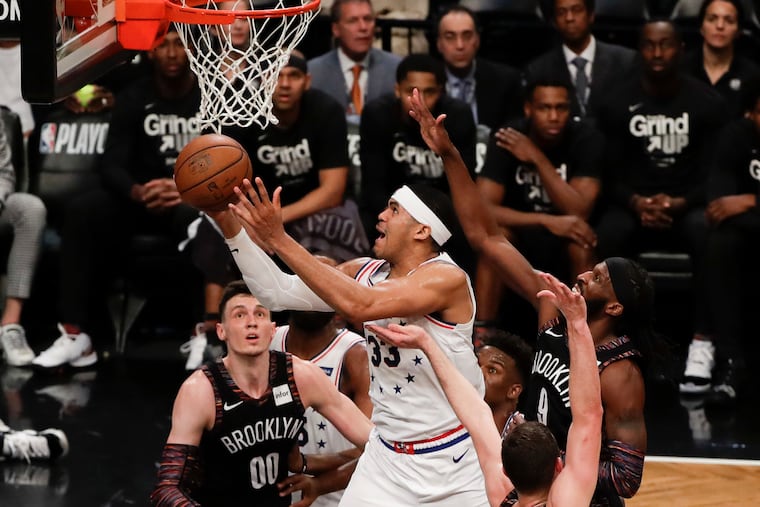 Sixers forward Tobias Harris drives to the basket past Brooklyn Nets forward DeMarre Carroll during the third-quarter in game three of the Eastern Conference playoffs on Thursday, April 18, 2019 in Brooklyn. Harris made the basket and got fouled on the play.