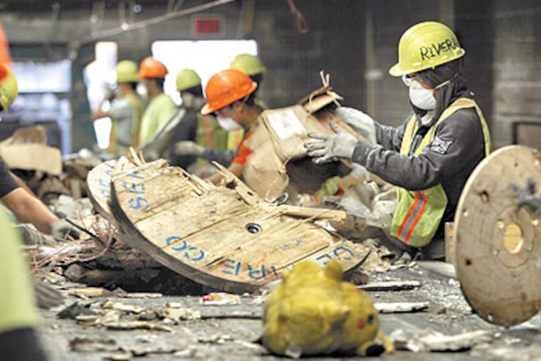 Workers recycle wood, cardboard, bricks, plastic, and wire from the debris. Revolution Recovery says it prevented 78 percent of what it took in from going to landfills last year.