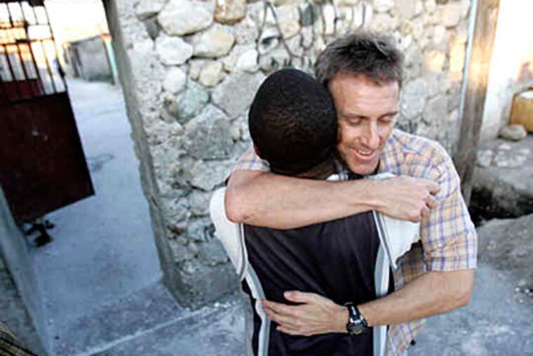 Philadelphia lawyer Thomas Griffin, who has visited Haiti for a decade and cofounded a medical clinic there in 2007, greets a friend in Port-au-Prince. Before he arrived, he wasn't sure what he would find. (David Swanson / Staff)
