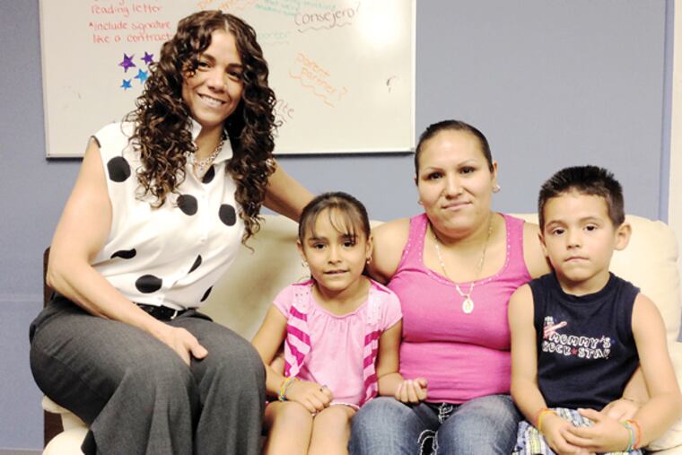 Maritza Rivera Cochran, left, interprets at medical appointments for Yuliana Vazquez, 30, who is seated with daughter Karen Castillo, 6, and son Brian Castillo, 5. (Michaelle Bond/Staff)