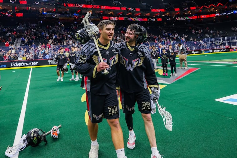 Brennan O'Neill (34) of the Wings is hugged by Sam LeClair after the team's final home game in Philadelphia.