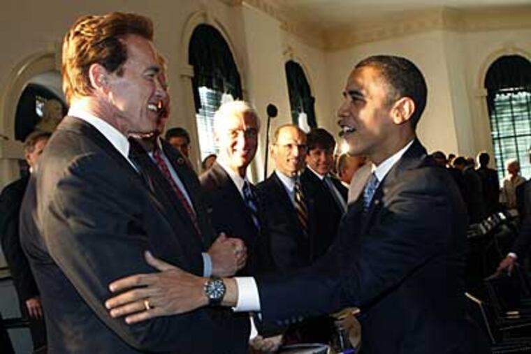 President-elect Barack Obama, right, greets California Gov. Arnold Schwarzenegger, left, at Congress Hall today. (AP / Pablo Martinez Monsivais)