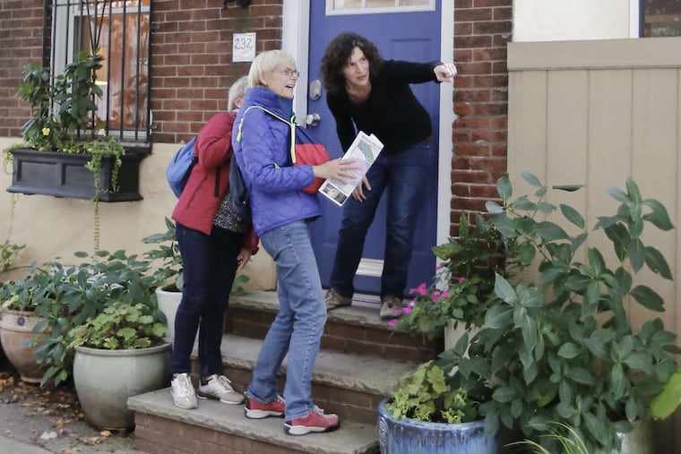 Airbnb host Carrie Borgenicht (on top step) gives directions to her guests Isabelle Jeanson (front) and Catherine Bretin, on left. Jeanson and Bretin had just arrived at Borgenicht's S. Phila. home on Nov. 1, 2017. Carrie Borgenicht has been an Airbnb host for nearly five years. She said the income helped her start an urban gardening business.