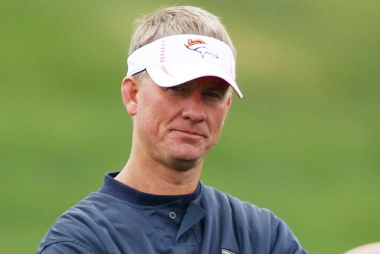 Denver Broncos offensive coordinator Mike McCoy, front, looks on during drills at the Broncos' NFL football rookie minicamp at the team's training headquarters in Englewood, Colo., on Saturday, May 12, 2012. (AP Photo/David Zalubowski)