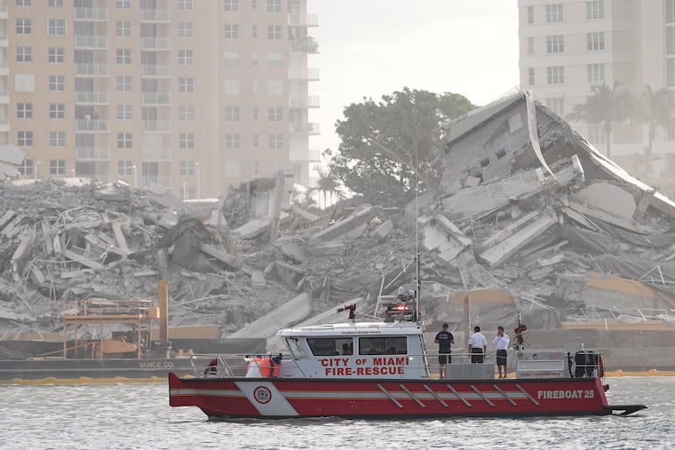 A Miami Fire-Rescue boat surveys debris following the controlled implosion of the former Mandarin Oriental Hotel on Brickell Key, Sunday, April 12, 2026, in Miami.