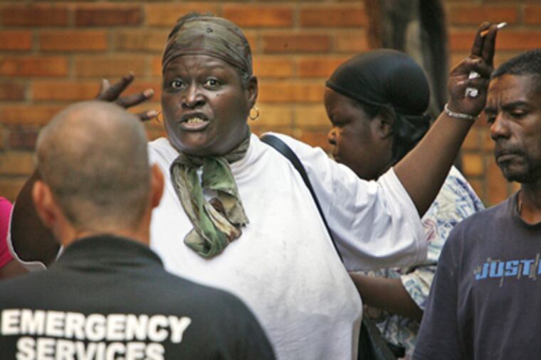 An unidentified resident of the Granada Apartments says she needs more time to remove her belongings from her apartment. (Alejandro A. Alvarez / Staff Photographer)