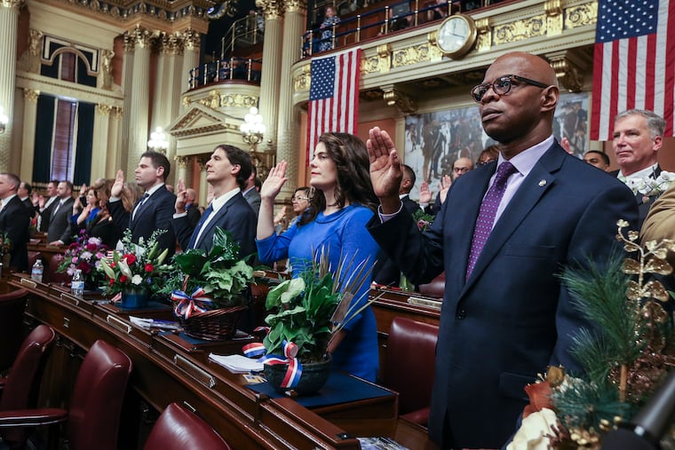 Philadelphia representative Elizabeth Fiedler, Democrat, center, takes the oath as a new member of the Pennsylvania state house in Harrisburg Jan. 1, 2019.