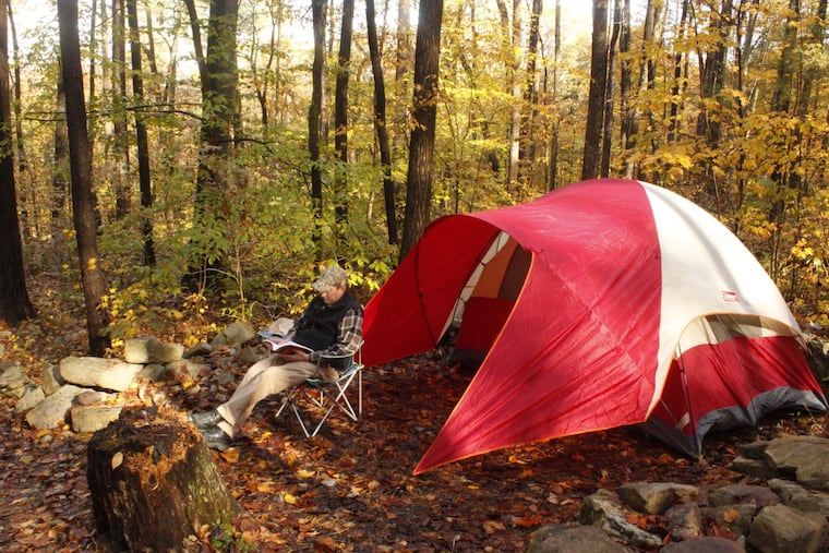 A camper sits outside his tent at a state park in Pennsylvania.