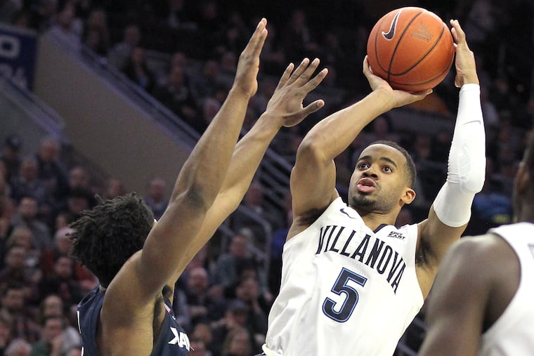 Phil Booth, right, of Villanova scores against Xavier during the 2nd half at the Wells Fargo Arena on Jan. 18, 2019.