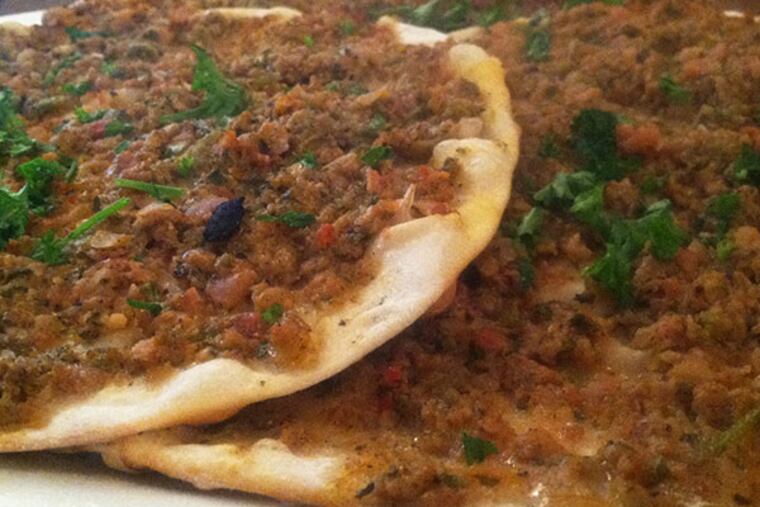 Turkish Lahmacun flatbreads topped with minced lamb from Leziz Turkish Cuisine. (Craig LaBan / Staff)