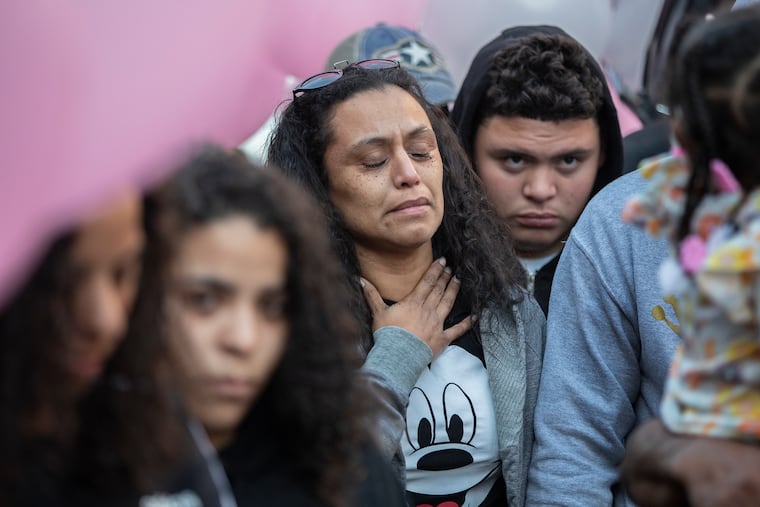 A family member of Nikolette Rivera, the 2-year-old who was shot and killed on Sunday, is overcome with emotion during the candlelight vigil that was held in front of the home in the Kensington area of Philadlephia, on Oct. 21, 2019.