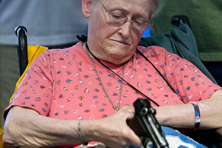 At the NRA convention, Janet Bero waits to have her German Luger appraised. The three-day event in Houston includes gun trade show, political rally, and strategy meeting. JOHNNY HANSON / Houston Chronicle