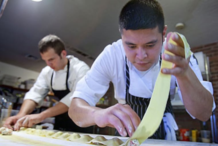 Chefs Richard Wright (right) and Neil Annis prepare lobster ravioli at Annis' East Berlin restaurant, Sidney, where both upscale and tavern menus are offered. (DAVID M WARREN / Staff Photographer)