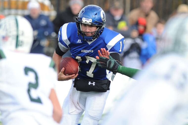 Quakertown quarterback Alec Vera heads for a wall of Pennridge defenders in the second quarter. His 1-yard, fourth-quarter plunge won the game.