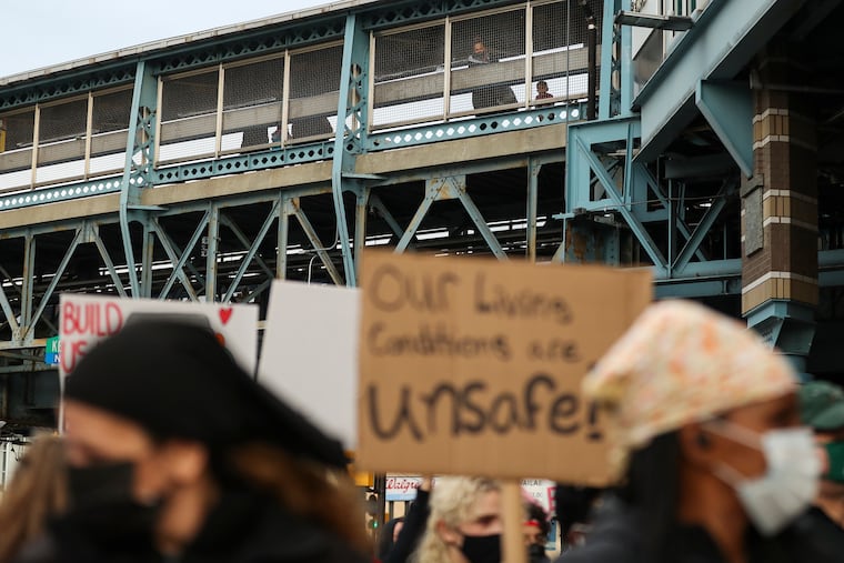 People watch from the platform of the SEPTA Allegheny Station on the Market-Frankford El, as a group of demonstrators gather underneath after a march to protest of SEPTA’s decision to close the Somerset Station last month.